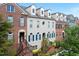 Row of townhomes featuring brick and painted facades, each with unique architectural details and entry staircases at 6459 Chariot St # 35, Atlanta, GA 30328