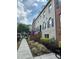 Inviting townhome with blue shuttered windows, brick accents, and inviting landscaped front at 6459 Chariot St # 35, Atlanta, GA 30328
