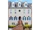 Charming townhome with a brick staircase leading to a stylish front entrance and blue shuttered windows at 6459 Chariot St # 35, Atlanta, GA 30328