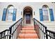Stylish entrance with brick steps, black iron railings, arched windows, and a dark wood door at 6459 Chariot St # 35, Atlanta, GA 30328