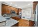 Modern kitchen features stainless steel appliances, granite counters, and door to balcony at 6459 Chariot St # 35, Atlanta, GA 30328