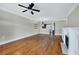 Open living room with hardwood floors, a fireplace, and kitchen views, great for entertaining at 6459 Chariot St # 35, Atlanta, GA 30328