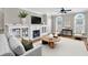 Bright living room features a fireplace, custom built-ins, and hardwood floors, styled with elegant decor at 6459 Chariot St # 35, Atlanta, GA 30328