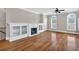 Spacious living room with hardwood floors, fireplace, built-in shelving, and ample natural light at 6459 Chariot St # 35, Atlanta, GA 30328