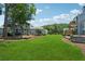 Lush backyard with green grass and mature trees, ideal for outdoor activities and relaxation at 1023 Riverbend Club Se Dr, Atlanta, GA 30339