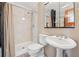 Cozy bathroom featuring neutral tones, a modern sink, toilet, and a walk-in shower with decorative tile at 1023 Riverbend Club Se Dr, Atlanta, GA 30339