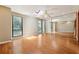 Serene bedroom with hardwood floors, a ceiling fan, mirrored closet doors, and natural light from multiple windows at 1023 Riverbend Club Se Dr, Atlanta, GA 30339