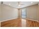 Cozy bedroom featuring a window, ceiling fan, and hardwood floors, creating a comfortable and inviting space at 1023 Riverbend Club Se Dr, Atlanta, GA 30339
