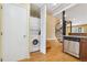 Efficient kitchen featuring a stacked laundry unit and spiral staircase, optimizing space and style at 1023 Riverbend Club Se Dr, Atlanta, GA 30339