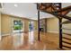 Bright living room with hardwood floors, stone fireplace, and sliding glass doors leading to the outdoors at 1023 Riverbend Club Se Dr, Atlanta, GA 30339