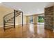 Bright living room with hardwood floors, stone fireplace, and sliding doors to a patio for indoor-outdoor living at 1023 Riverbend Club Se Dr, Atlanta, GA 30339