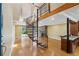 Bright living room with hardwood floors, fireplace, and spiral staircase to the second floor at 1023 Riverbend Club Se Dr, Atlanta, GA 30339