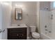Clean bathroom features a vanity with dark wood cabinet, toilet, and shower at 132 Brownlee Sw Rd, Atlanta, GA 30331