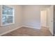 Bedroom with hardwood floors, natural light, white trim, and an open white door at 132 Brownlee Sw Rd, Atlanta, GA 30331