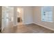 Bedroom view with hardwood floors and glimpses of an attached bathroom and the open floor plan at 132 Brownlee Sw Rd, Atlanta, GA 30331