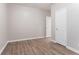 Bedroom features hardwood floors, neutral walls, white baseboards, and two white doors at 132 Brownlee Sw Rd, Atlanta, GA 30331