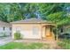 Charming single-story home with a welcoming front porch and freshly cut grass at 132 Brownlee Sw Rd, Atlanta, GA 30331