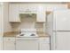 Compact kitchen area with white appliances, storage, and laminate countertops at 132 Brownlee Sw Rd, Atlanta, GA 30331