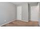 Cozy bedroom with neutral paint and carpet, featuring two closets for ample storage at 1377 Mill Lake Cir, Stone Mountain, GA 30088