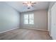Bright bedroom featuring a ceiling fan and closet at 1377 Mill Lake Cir, Stone Mountain, GA 30088