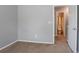Neutral bedroom featuring a door to the bathroom and carpeted floors at 1377 Mill Lake Cir, Stone Mountain, GA 30088