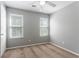 Bright bedroom with two windows, ceiling fan, and neutral carpeting at 1377 Mill Lake Cir, Stone Mountain, GA 30088