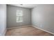 A simply furnished bedroom with a window and neutral walls and carpeting at 1377 Mill Lake Cir, Stone Mountain, GA 30088
