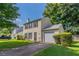 View of home with green yard, dark shutters, one-car garage, and paved driveway at 1377 Mill Lake Cir, Stone Mountain, GA 30088