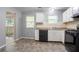 Well-lit kitchen featuring ample counter space and updated black appliances at 1377 Mill Lake Cir, Stone Mountain, GA 30088