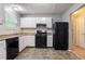 Functional kitchen featuring white cabinets, black appliances, and a well-lit area at 1377 Mill Lake Cir, Stone Mountain, GA 30088