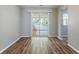 Bright living room featuring modern wood floors and sliding glass doors to the outside at 1377 Mill Lake Cir, Stone Mountain, GA 30088