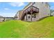 Spacious backyard featuring a private deck, lush green lawn, and walkout basement access at 2090 Beckham St, Cumming, GA 30041