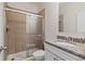 Tiled bathroom features glass-enclosed shower, granite vanity and modern fixtures at 2090 Beckham St, Cumming, GA 30041