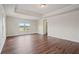 Large bedroom features tray ceiling, recessed lighting and multiple windows at 2090 Beckham St, Cumming, GA 30041