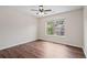 Bedroom with hardwood floors, ceiling fan and a bright window with neighborhood views at 2090 Beckham St, Cumming, GA 30041