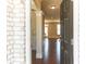 View of entryway with dark wood floors that leads to a bright living space with recessed lighting at 2090 Beckham St, Cumming, GA 30041