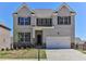 Beautiful two-story brick home with manicured lawn and attached two car garage at 2090 Beckham St, Cumming, GA 30041
