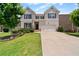 Charming two-story home with light brick exterior, well-manicured lawn, and attached two car garage at 2090 Beckham St, Cumming, GA 30041
