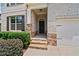Inviting front entrance with brick and stone accents, black front door and manicured bushes at 2090 Beckham St, Cumming, GA 30041