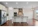 Modern kitchen features stainless steel appliances, granite countertops, and a center island with seating at 2090 Beckham St, Cumming, GA 30041