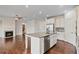 Spacious kitchen with stainless steel appliances and granite countertop with view of living room at 2090 Beckham St, Cumming, GA 30041