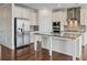 Bright kitchen features stainless steel appliances, granite counters and white cabinetry at 2090 Beckham St, Cumming, GA 30041