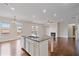 Bright kitchen island featuring stainless steel appliances and granite countertop, opens to living room at 2090 Beckham St, Cumming, GA 30041