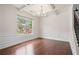 Living room with large window, hardwood floors, decorative trim, and chandelier at 2090 Beckham St, Cumming, GA 30041