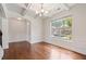 Bright, airy living room with hardwood floors, large window, and decorative molding at 2090 Beckham St, Cumming, GA 30041