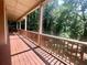 Long deck with railing overlooking serene treed backyard at 2961 River Ridge Drive Sw, Atlanta, GA 30354