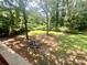 Large backyard features mature trees and a fire pit, great for outdoor entertaining at 2961 River Ridge Drive Sw, Atlanta, GA 30354