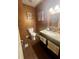 Bathroom with granite countertops and dark wood cabinets with a toilet in the corner at 2961 River Ridge Drive Sw, Atlanta, GA 30354