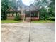 Charming two-story home with a welcoming front porch and well-manicured lawn surrounded by lush trees at 2961 River Ridge Drive Sw, Atlanta, GA 30354