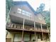 Rear exterior with a large deck and a walkout basement with two garage doors at 2961 River Ridge Drive Sw, Atlanta, GA 30354